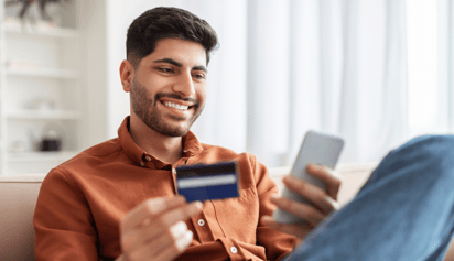 man using his credit card on his phone